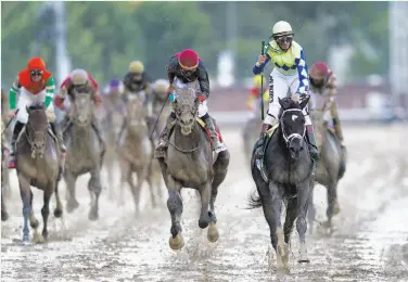  ?? Patrick Smith / Getty Images ?? John Velazquez rises to celebrate atop Always Dreaming after crossing the finish line to win the Derby.