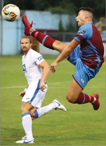  ??  ?? Chris Lyons acrobatica­lly brings the ball down as Harps defender Keith Cowan looks on.