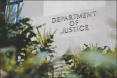  ?? PATRICK SEMANSKY/AP ?? A SIGN MARKS AN ENTRANCE to the Robert F. Kennedy Department of Justice Building in Washington on Jan. 23, 2023.