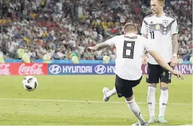  ??  ?? Germany’s Toni Kroos (left) scores his side’s winning goal against Sweden at the 2018 World Cup on Saturday, June 23. At right is Marco Reus.