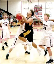  ?? RANDY MOLL WESTSIDE EAGLE-OBSERVER ?? Prairie Grove senior Anthony Johnson gets past Gentry defenders for a shot in the paint. Johnson scored six points in the Tigers’ 69-48 road win over the Pioneers on Jan. 19. Johnson is the Enterprise-Leader’s male Athlete of the Year for school year 2017-2018 at Prairie Grove.