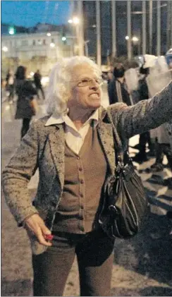  ?? Yorgos Karahalis, Reuters ?? Above, a protester argues with police at a rally in Syntagma Square in Athens on Thursday. A pensioner’s suicide outside parliament has sparked more protests.