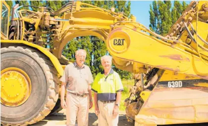  ??  ?? Hatuma Lime Co owner Clifford Topp, with Tom Henderson and one of the motor scrapers Tom has enjoyed operating.