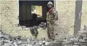  ?? ASSOCIATED PRESS ?? An army soldier examines damages on the site of a bombing Tuesday at a police station on the outskirts of Dera Ismail Khan, Pakistan.