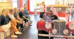  ??  ?? Left, museum manager Paula Gaelic shares the history of race car champion Denny Hulme.