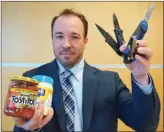  ?? STEVE MacNAULL/The Daily Courier ?? Canadian Air Transporta­tion Security Authority spokesman Mathieu Larocque shows handfuls of intercepte­d and confiscate­d items at a Kelowna airport event Thursday reiteratin­g what passengers can and can’t carry on planes.