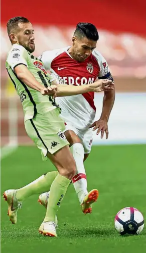  ??  ?? Eyes on the ball: Monaco forward Radamel Falcao (right) in action against Angers midfielder Flavien Tait during the Ligue 1 match at the Louis II Stadium on Tuesday. — AFP