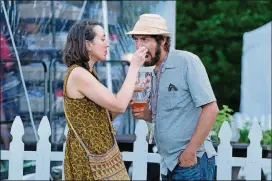  ?? AJC FILE ?? Danielle Arellano feeds her husband, Robby Astrove, a bite while sampling the food at the Atlanta Food and Wine Festival’s Friday Night Bites event at Piedmont Park in 2016.