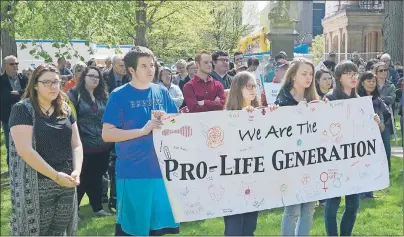  ?? MITCH MACDONALD/THE GUARDIAN ?? Young Islanders in the March for Life hold up a sign during a rally in front of the Coles Building on Sunday. The group said there “has never been a more important time” to share their message.