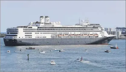  ?? Wilfredo Lee / Associated Press ?? The cruise ship Rotterdam turns as it prepares to dock at Port Everglades on April 2 in Fort Lauderdale, Fla. Federal health officials are extending the U.S. ban on cruise ships through the end of September as coronaviru­s infections rise in most U.S. states, including Florida.