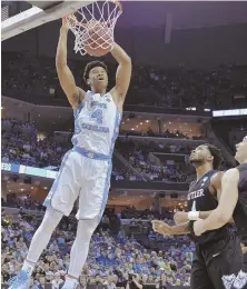  ?? AP PHOTO ?? CAN ONLY WATCH: Isaiah Hicks throws down a dunk during North Carolina’s 92-80 win over Butler in the South Regional last night in Memphis.