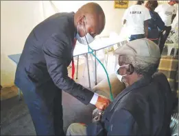  ??  ?? MDPPZA interim president Johannes Marisa examines an elderly inmate at Bako Redonhodzo Old People's Home in Highfield, Harare, on Sunday