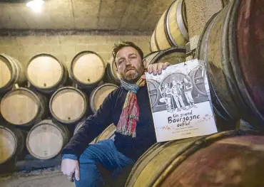  ?? AFP ?? Organic winemaker Emmanuel Guillot poses with his comic book in his cellar in Cruzille in northeaste­rn France.