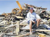  ?? Bob Owen / San Antonio Express-News ?? Gray Gant, 51, who grew up in Port Aransas, sits on the pile of rubble that was the house he lived in when Hurricane Harvey hit in 2017. He received a letter of denied coverage from FEMA.