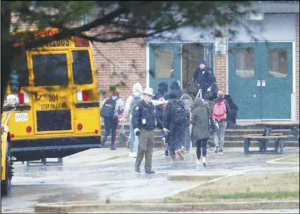  ?? AP PHOTO ?? Police move students into a different area of Great Mills High School, the scene of a shooting in Great Mills, Md.