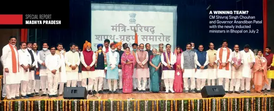  ?? ANI ?? A WINNING TEAM? CM Shivraj Singh Chouhan and Governor Anandiben Patel with the newly inducted ministers in Bhopal on July 2