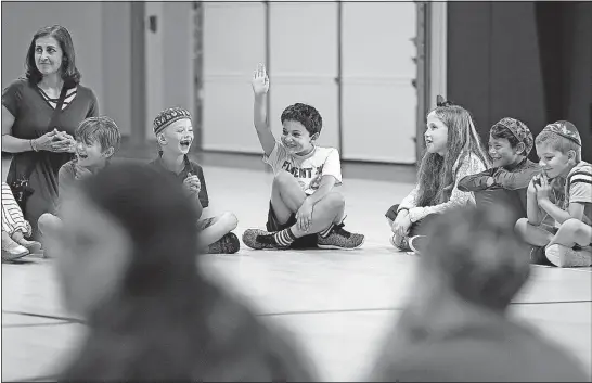  ?? [JONATHAN QUILTER PHOTOS/DISPATCH] ?? Second-grader Zeke Moses, 7, asks a question during an assembly Thursday when students learned of their new principal at the Columbus Jewish Day School in New Albany.