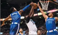  ?? THE CANADIAN PRESS/FRANK GUNN ?? Charlotte Hornets forward Michael Kidd-Gilchrist (14) is blocked by Toronto Raptors guard Delon Wright (55) and guard Norman Powell (24) during second half NBA basketball action in Toronto on Wednesday.