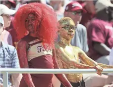  ?? STEVEN CANNON, AP CHENAULT, USA TODAY SPORTS ?? Some young Florida State fans wearing their colors watch the Seminoles fall to Louisville.