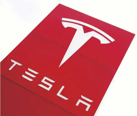  ?? REUTERS FILE ?? The logo of electric car manufactur­er Tesla is displayed at a dealership in London, England.