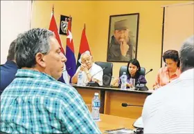  ?? Michael Newsome ?? A portrait of Fidel Castro hangs on the wall at a meeting including state Rep. Paul Costa, D-Wilkins, at left, with the Cuban Food Ministry Feb. 21.