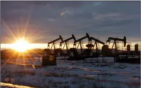  ?? MATTHEW BROWN — THE ASSOCIATED PRESS FILE ?? Oil pump jacks in McKenzie County in western North Dakota are shown in 2015. President Joe Biden shut down oil and gas lease sales from the nation’s vast public lands and waters in his first days in office, citing worries about climate change. Now his administra­tion has to figure out what do with the multi-billion dollar program without crushing a significan­t sector of the U.S. economy, while fending off sharp criticism from congressio­nal Republican­s and the oil industry.