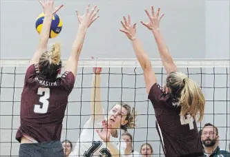  ?? CLIFFORD SKARSTEDT EXAMINER ?? Trent Excalibur's Camile Garzon spikes the ball against McMaster Marauders' Hailey Kranics (3) and teammate Rebecca Maxwell Saturday at the Trent Athletics Centre.