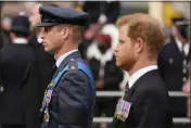  ?? ALBERTO PEZZALI — THE ASSOCIATED PRESS FILE ?? Prince William, center, and Prince Harry walk behind the coffin of Queen Elizabeth II as it is being pulled past Buckingham Palace in central London on Sept. 19 following her funeral service at Westminste­r Abbey.