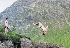  ??  ?? Swimmers do backflips into the River Etive