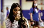  ?? Bob Owen / Staff photograph­er ?? Sophomore Monique Perez swabs her nose in a COVID-19 test at Somerset High School.