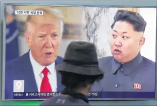  ?? AP PHOTO ?? In this Aug. 10 file photo, a man watches a TV screen showing U.S. President Donald Trump and North Korean leader Kim Jong Un during a news program at the Seoul Train Station in Seoul, South Korea, following North Korea’s strongest ever nuclear test...