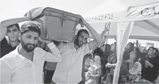  ?? MAHMUT BOZARSLAN, AP ?? Mourners carry a victim’s coffin at a funeral Sunday for dozens killed in a bomb attack the day before in Gaziantep, Turkey.