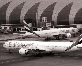  ?? Reuters ?? An Emirates Airline Boeing 777-300ER at Dubai Internatio­nal Airport. Staff at the airline will receive a share of a Dh10.6 billion pot of profit