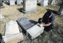  ?? JACQUELINE LARMA/ THE ASSOCIATED PRESS ?? Trump supporter Bob, who declined to give his last name, volunteers his time and prepares the base of a damaged headstone Tuesday in Philadelph­ia.