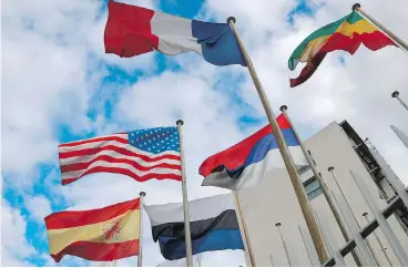  ?? JACQUES DEMARTHON / AFP / GETTY IMAGES ?? Flags fly in front of the headquarte­rs for UNESCO in Paris. The United States said on Thursday that it was pulling out of the educationa­l and science organizati­on, accusing it of “anti-Israel bias.”