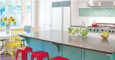  ??  ?? A youthful combinatio­n of seating colours adds zing to this kitchen.