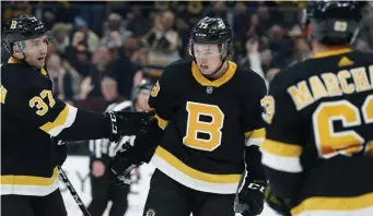  ?? AP ?? ‘SPECIAL NO MATTER WHAT’: Bruins defenseman Charlie McAvoy, center, celebrates a goal against the Rangers with teammates Patrice Bergeron and Brad Marchand.