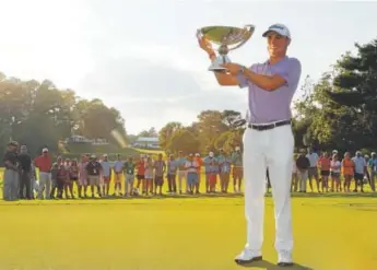  ?? Kevin C. Cox, Getty Images ?? Justin Thomas is all smiles after winning the FedEx Cup and the $10 million bonus that comes with it. He was runner-up at the Tour Championsh­ip, which Xander Schauffele won.