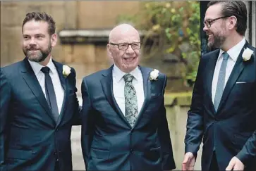  ?? Leon Neal AFP/Getty Images ?? RUPERT MURDOCH is flanked by sons Lachlan, left, and James in 2016. Most of their 21st Century Fox business empire is being purchased by Disney. Lachlan Murdoch will run a new, smaller Fox.