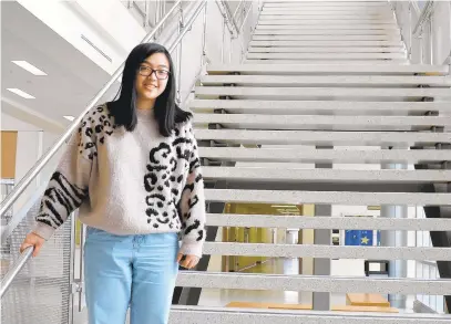  ?? SHARON LEE TEGLER/CAPITAL GAZETTE ?? Severna Park High School senior Allison Chang heads from a computer science STEM class to a meeting on the first floor. Meetings are a constant for Allison, as she is the Key Club “editor” and also chairs two of the organizati­on’s event-planning committees.