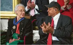  ?? Evan Vucci / Associated Press ?? Baseball legend Willie Mays applauds Katherine Johnson after she received the Presidenti­al Medal of Freedom in 2015.