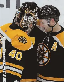  ??  ?? CROWD-PLEASING EFFORT: Patrice Bergeron hugs goalie Tuukka Rask following yesterday’s 6-3 victory against the Senators, which included the Bruins forward surrounded by hats after his three-goal performanc­e; at right, Rask braces for a collision with Ottawa’s Alex Formenton.