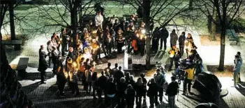  ??  ?? People sing “Amazing Grace” during a candleligh­t vigil Monday for missing Duquesne University graduate student Dakota Leo James at Katz Plaza in the Cultural District.