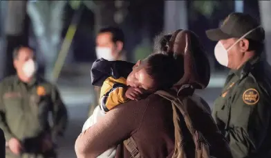  ?? JULIO CORTEZ AP ?? A migrant child sleeps on the shoulder of a woman at an intake area after crossing the U.S.-Mexico border early Wednesday in Roma, Texas. There are about 16,000 unaccompan­ied migrant children in U.S. custody.