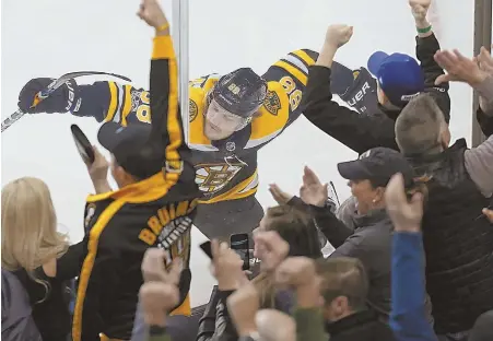  ?? STAFF PHOTO BY JOHN WILCOX ?? PUMPED: David Pastrnak celebrates in front of the Garden fans after scoring the deciding goal on a breakaway in the third period of the Bruins’ 4-3 victory against the Penguins yesterday.