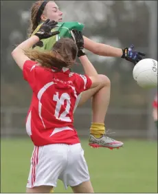  ??  ?? Michaela Farrell (HWH-Bunclody) goes high in this tussle with Chloe Waters of Fethard St. Mogue’s.