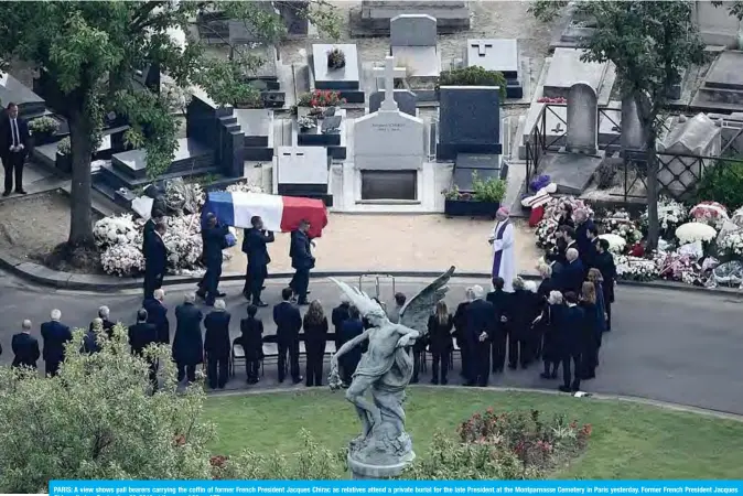  ??  ?? PARIS: A view shows pall bearers carrying the coffin of former French President Jacques Chirac as relatives attend a private burial for the late President at the Montparnas­se Cemetery in Paris yesterday. Former French President Jacques Chirac died on September 26, 2019 at the age of 86. —AFP