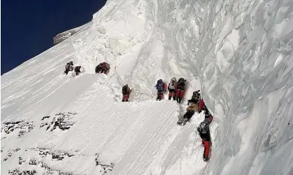  ?? Photograph: Lakpa Sherpa (8k Expedition­s) / Instagram ?? Mohammed Hassan, seen lying prone on the ground, had fallen from a sheer ledge during the ascent.