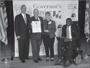  ?? SUBMITTED PHOTO ?? Carolyn Core, center, receives a Governor’s Service Award on Oct. 16. From left are Steven J. McAdams, executive director of the Governor’s Office of Community Initiative­s, Health Secretary Robert R. Neal, Core and Van Brooks, director of the Governor’s Office on Service and Volunteeri­sm.