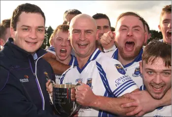  ??  ?? Gary Keating of Craanford receives the cup from Cathal Byrne (Co. Developmen­t Officer).